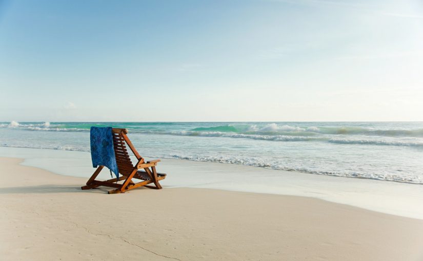 Best Beaches in North Carolina | View of lone chair facing the ocean